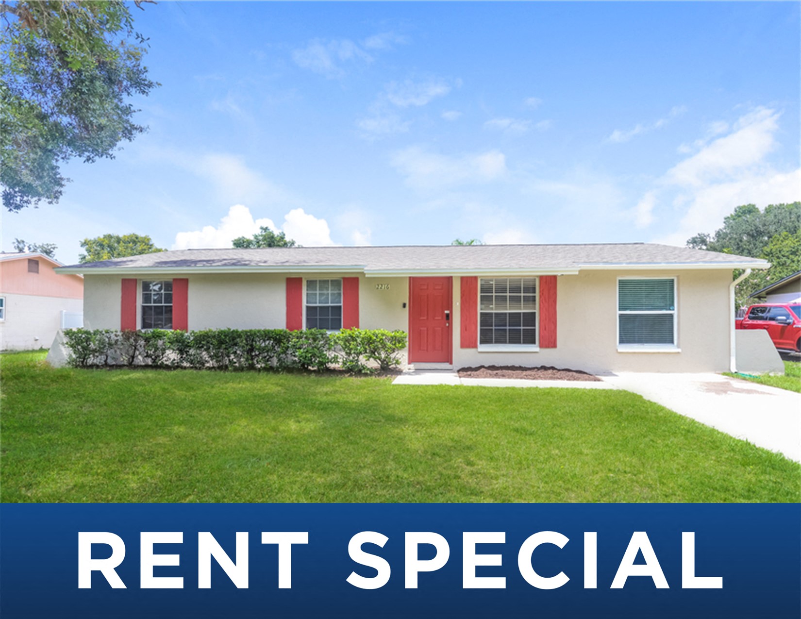 a house with red doors and a lawn
