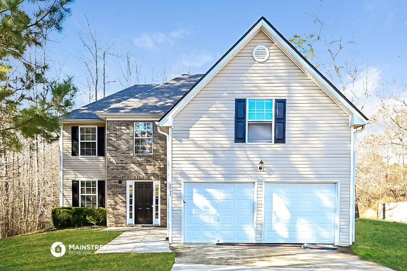 a white house with a blue garage door