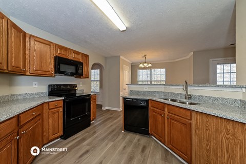 a kitchen with an island and a stove and a sink