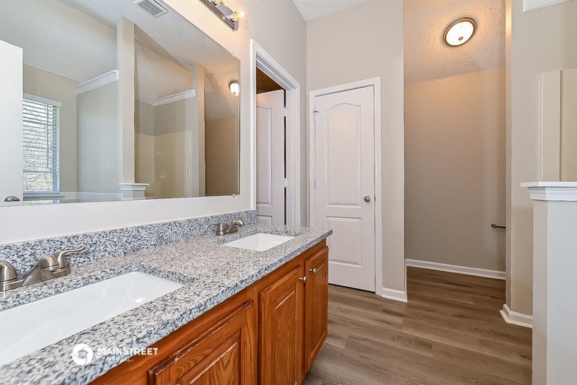 a bathroom with two sinks and a large mirror