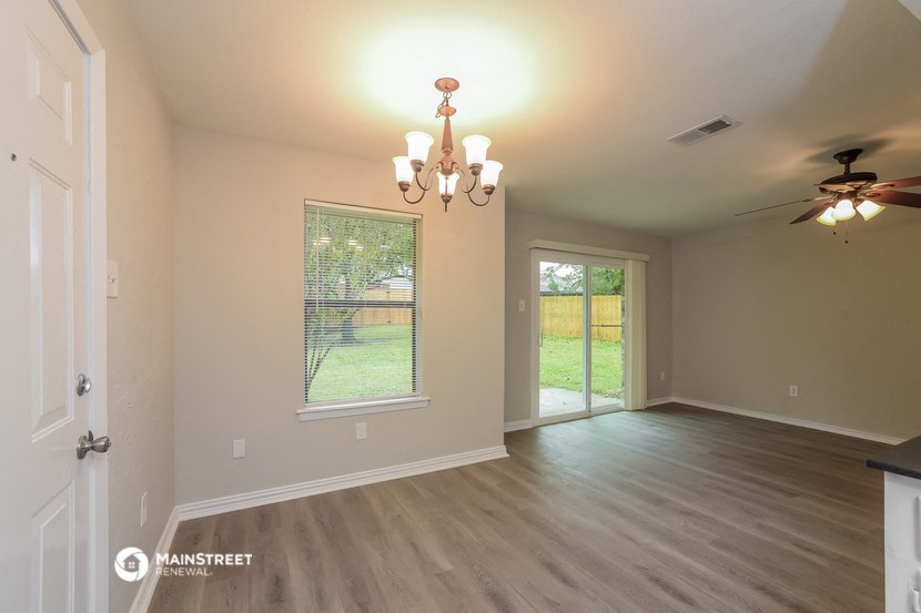 the living room and dining room of an empty house