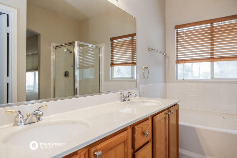 a bathroom with two sinks and a large mirror