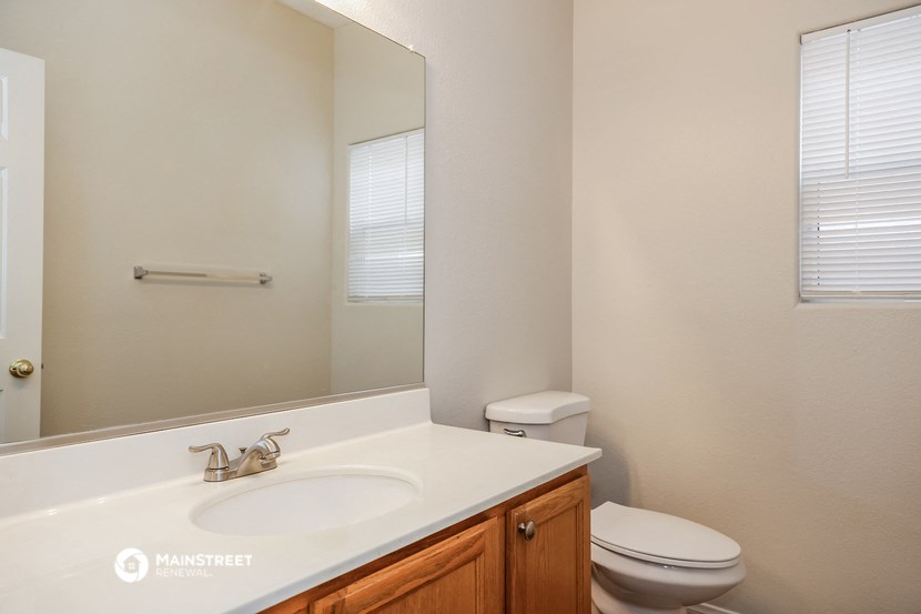 a bathroom with a sink toilet and a mirror