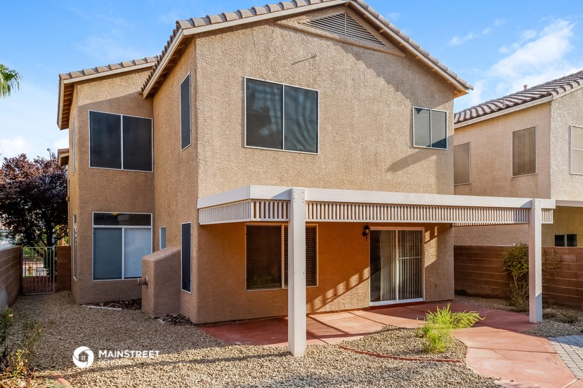 a beige house with a porch and a pathway