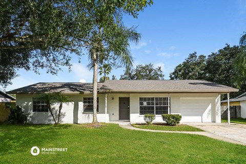 a white house with a palm tree in the front yard