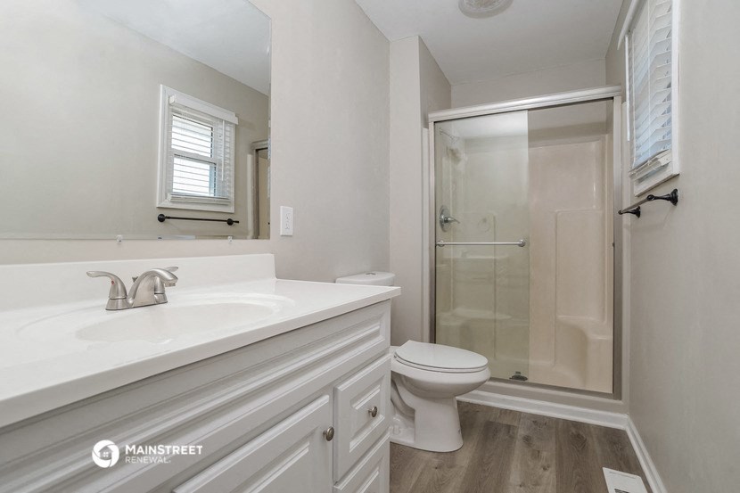 a bathroom with a sink toilet and a shower