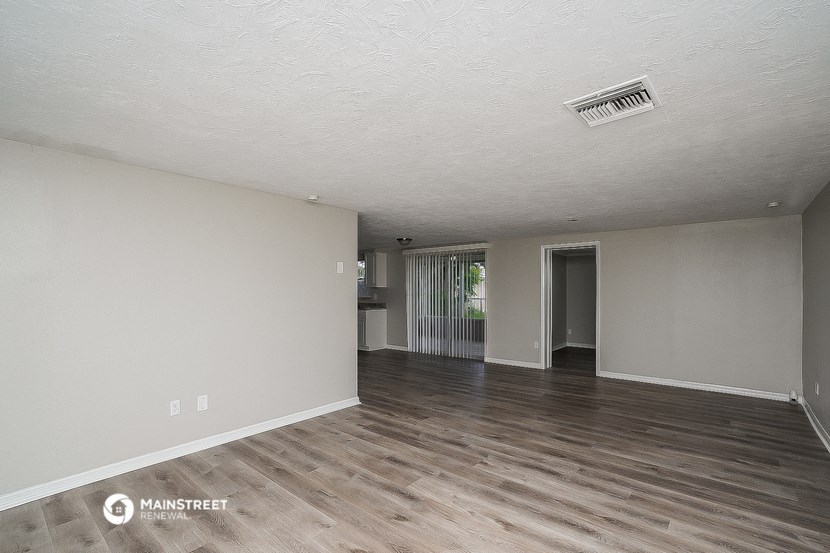 the living room and dining room of an apartment