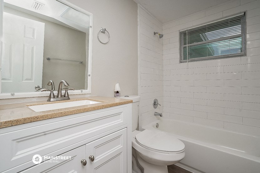 a bathroom with a sink and a toilet and a tub