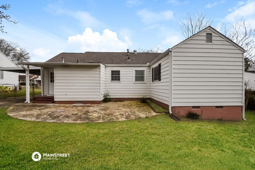 a white house with a yard and a patio