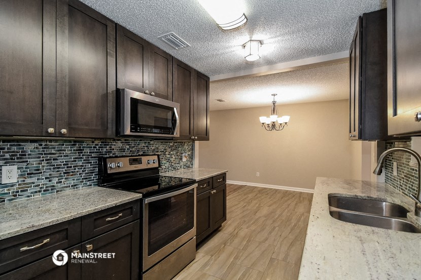 a kitchen with stainless steel appliances and wooden cabinets