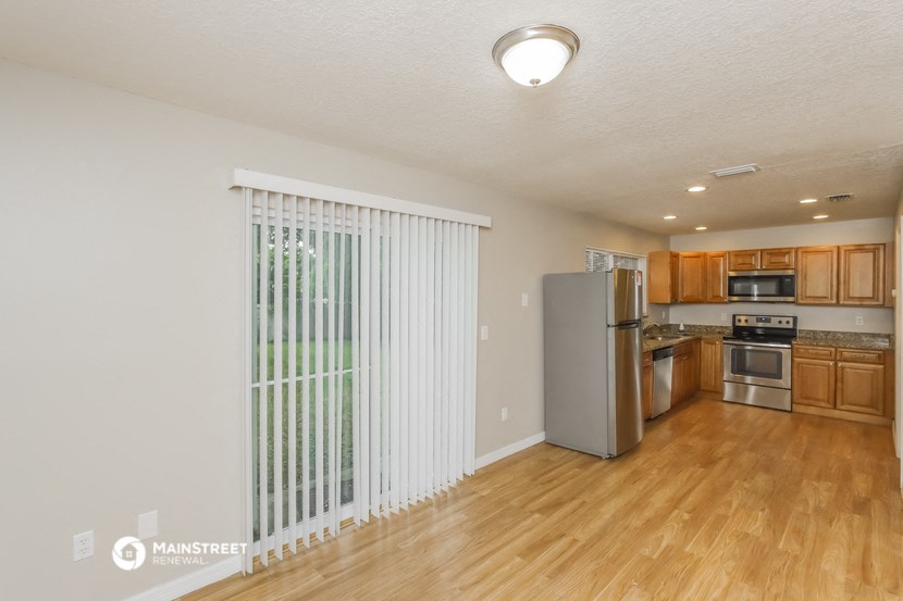 the living room and kitchen of an apartment