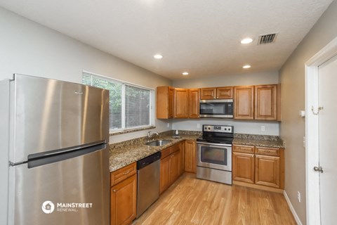 a kitchen with stainless steel appliances and wooden cabinets