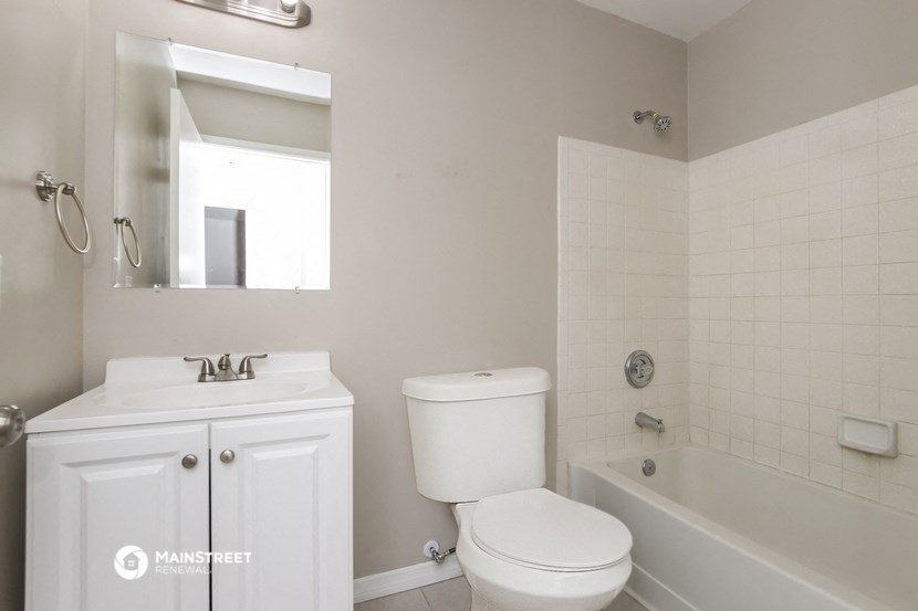 a bathroom with a sink toilet and a bath tub