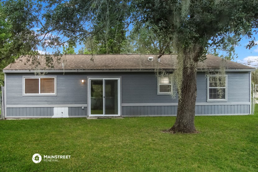 a blue house with a tree in front of it