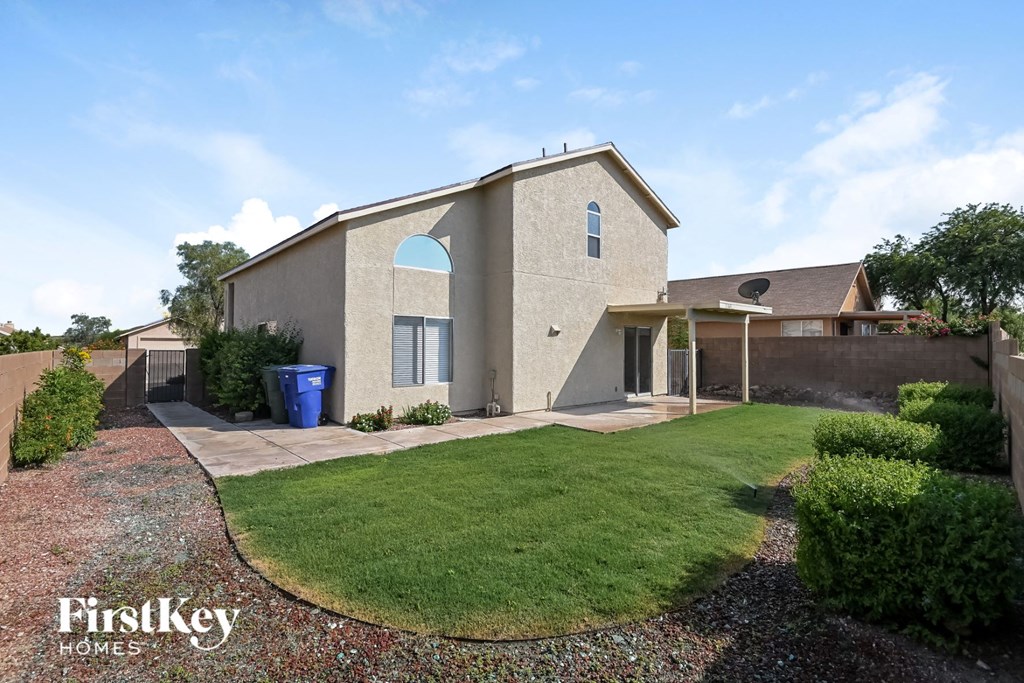 a house with a lawn and a driveway in front of it