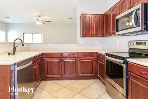A kitchen with brown cabinets and a white countertop.