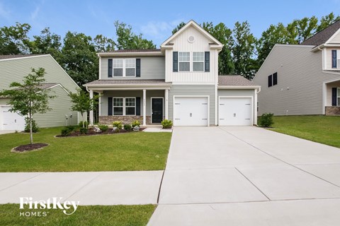 a white house with white shutters and a white driveway