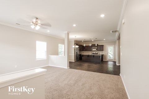 a spacious living room and kitchen in a new home