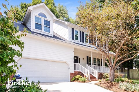 a white house with a white garage door