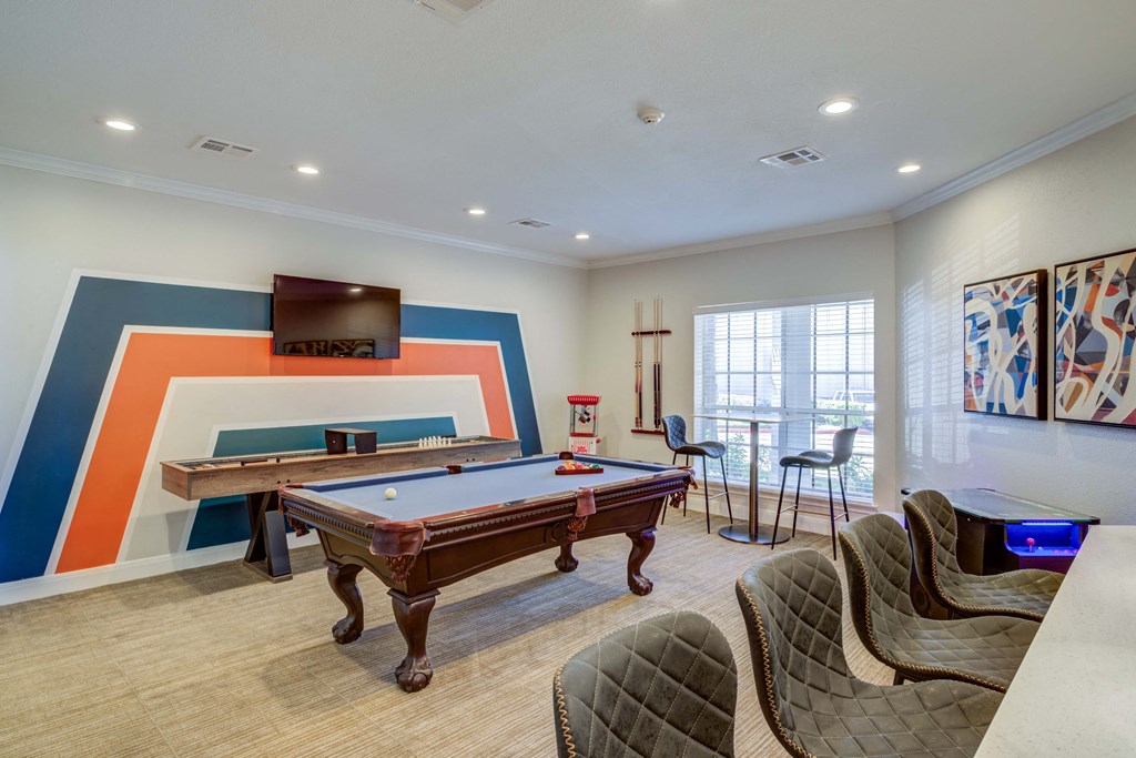 a game room with a pool table and a television