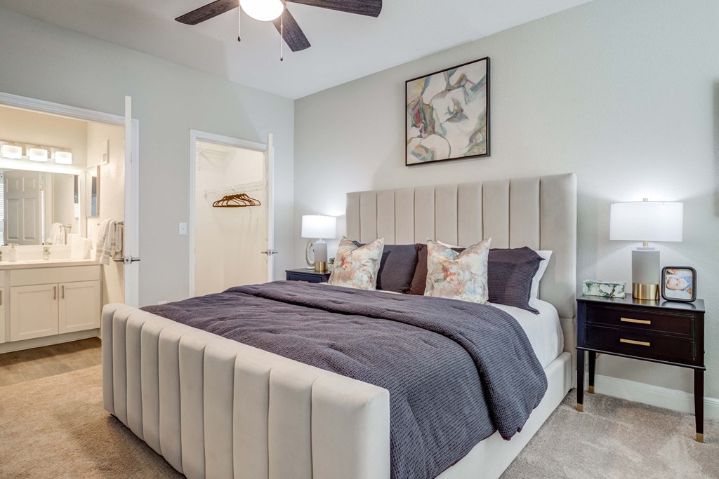 a bedroom with a bed and a ceiling fan