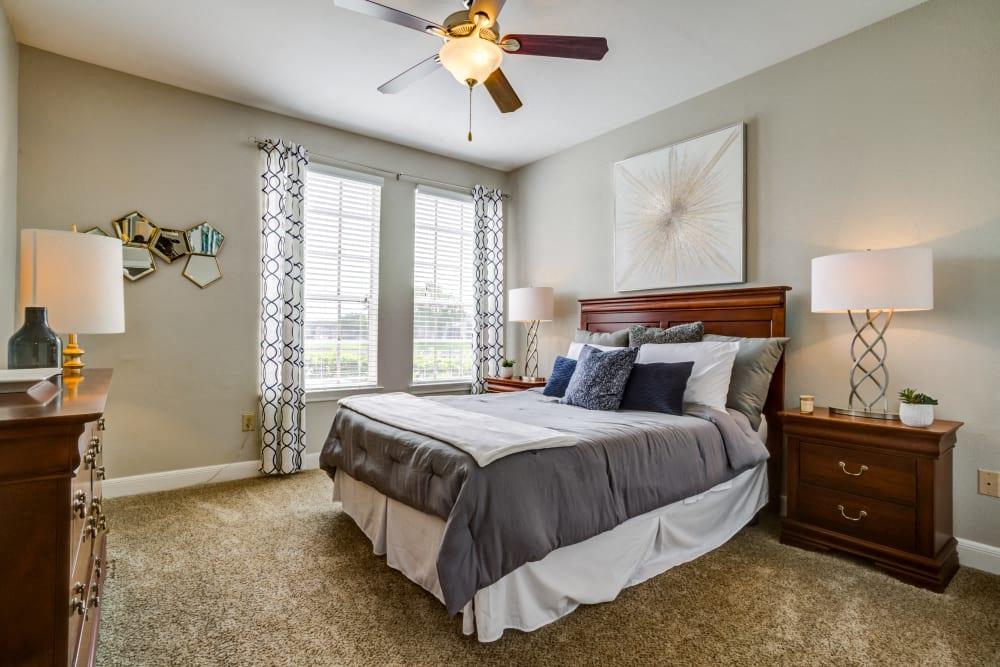 a bedroom with a bed and a ceiling fan