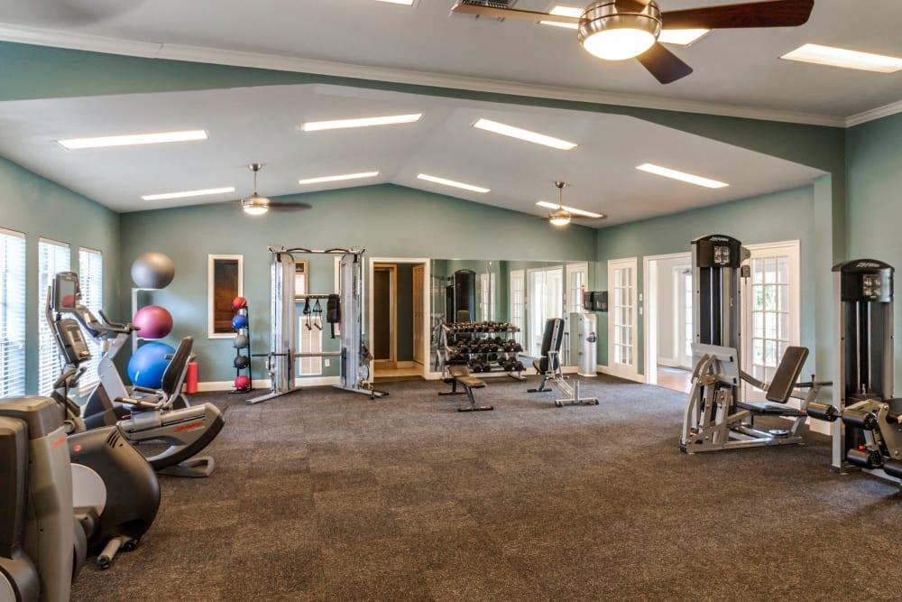 a workout room with weights and cardio equipment in a home gym