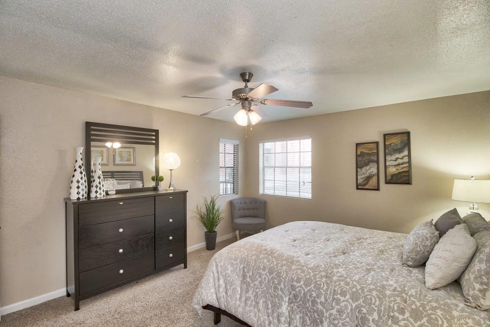 a bedroom with a bed and a ceiling fan