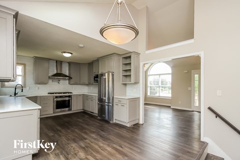 an open kitchen with white cabinets and stainless steel appliances