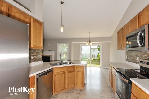 a kitchen with wooden cabinets and stainless steel appliances