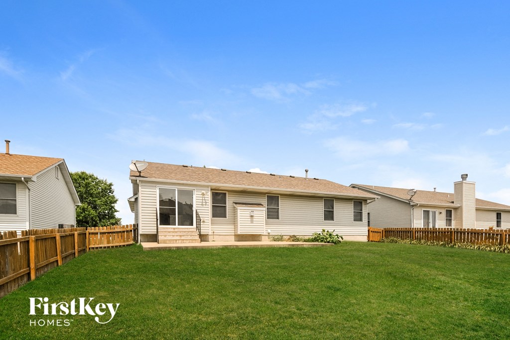 a house with a yard and a fence