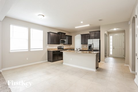 a kitchen with black cabinets and a white counter top