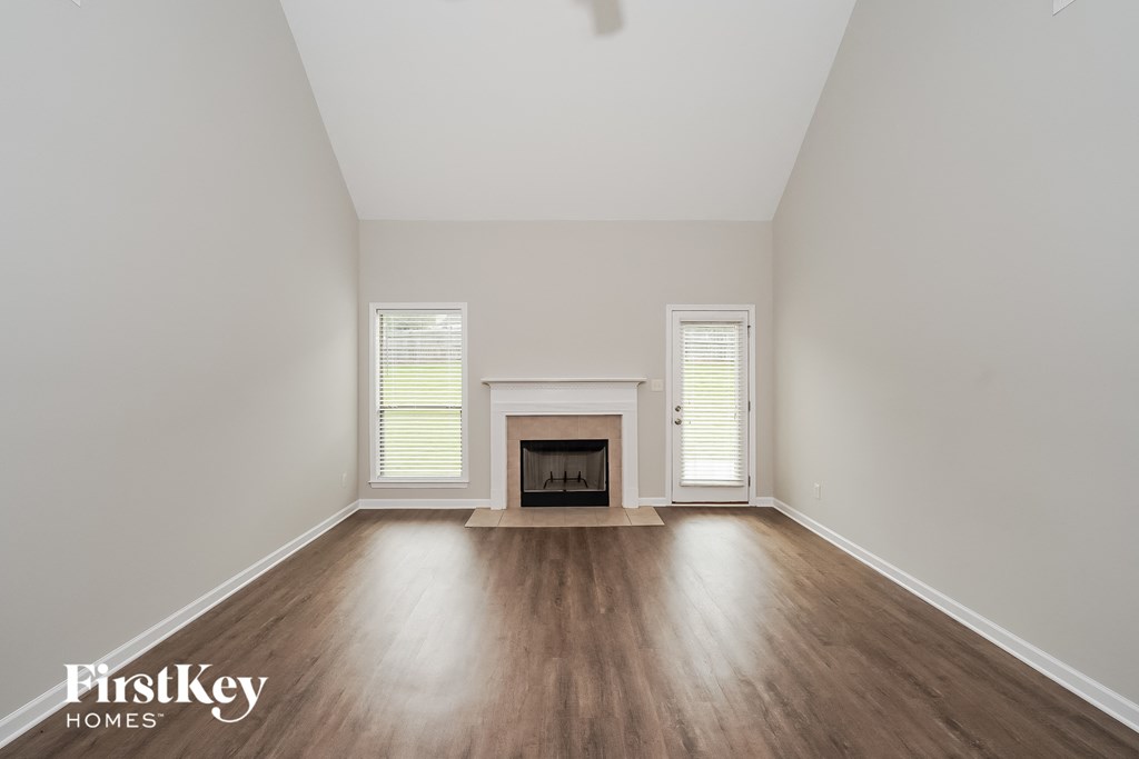 a living room with wood floors and a fireplace