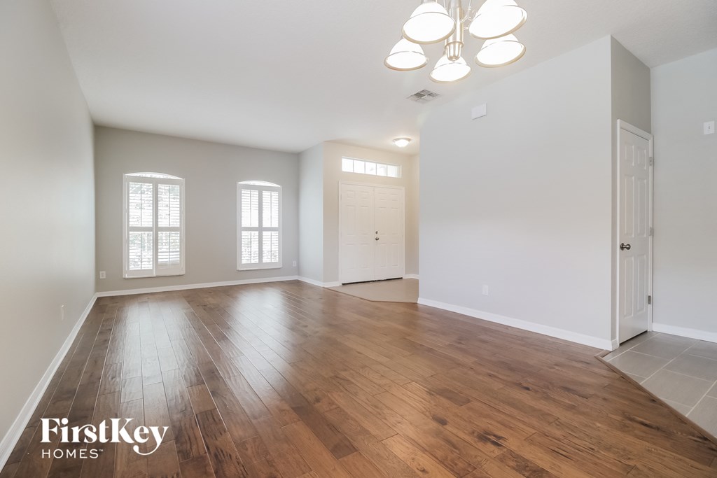 the living room and dining room with hardwood flooring