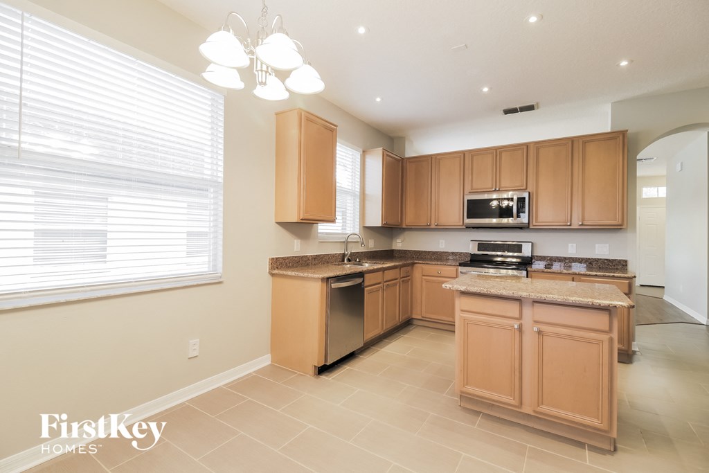 a kitchen with wooden cabinets and granite counter tops