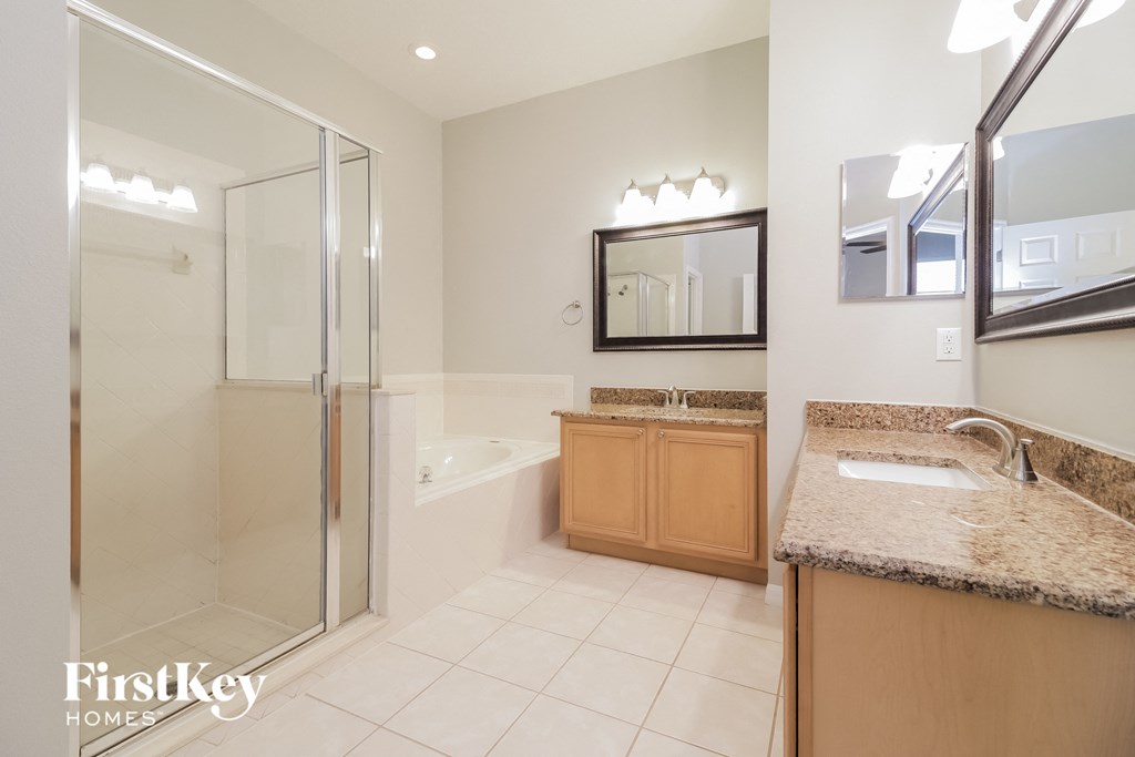 a bathroom with a shower and a sink and a mirror