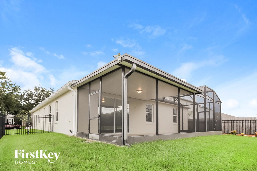 a new home with glass windows and a grass yard