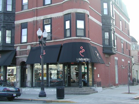 a building with a black awning on a city street
