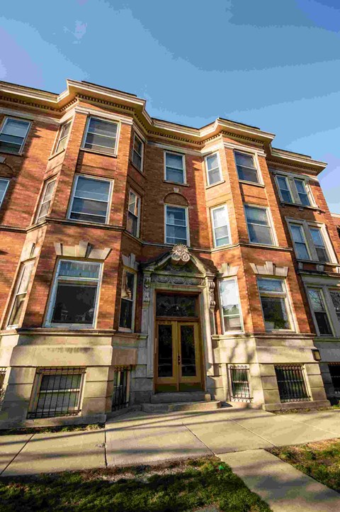 a red brick building with a golden door and windows