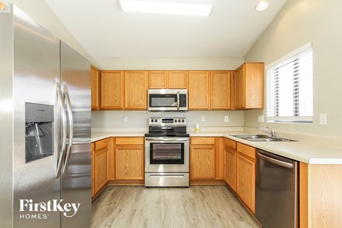 A kitchen with wooden cabinets and stainless steel appliances.