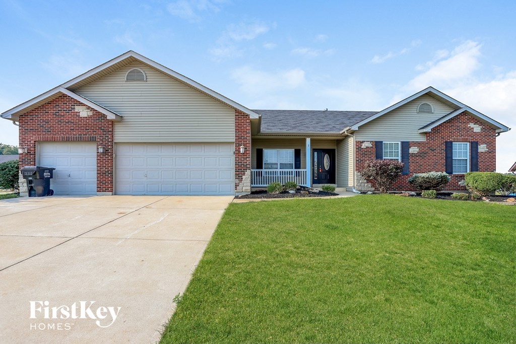 a house with a lawn and a driveway
