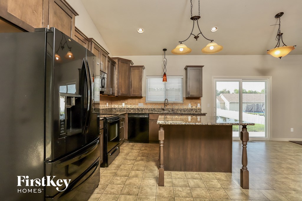 a kitchen with stainless steel appliances and a large island