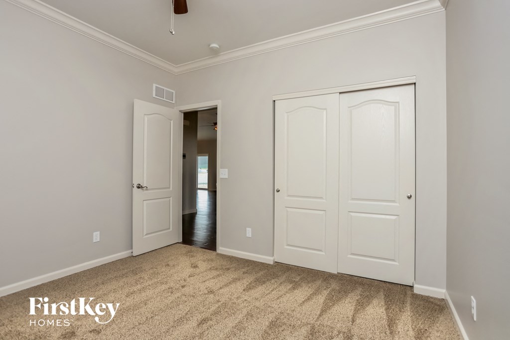 a bedroom with two closets and a door to a hallway