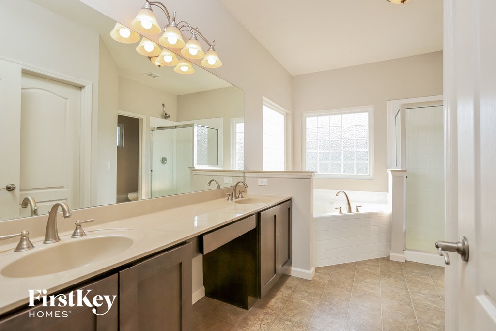 a bathroom with a sink and a mirror and a tub