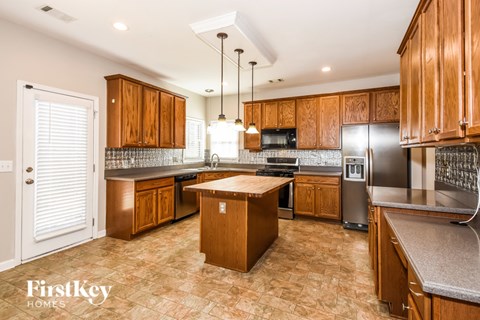 A kitchen with wooden cabinets and a central island.