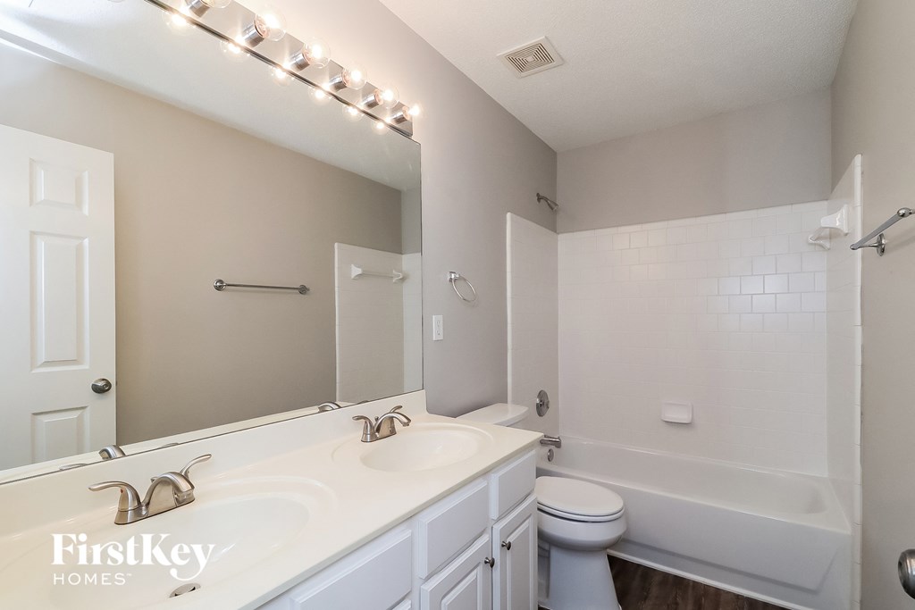 a bathroom with a white sink and a tub and a toilet