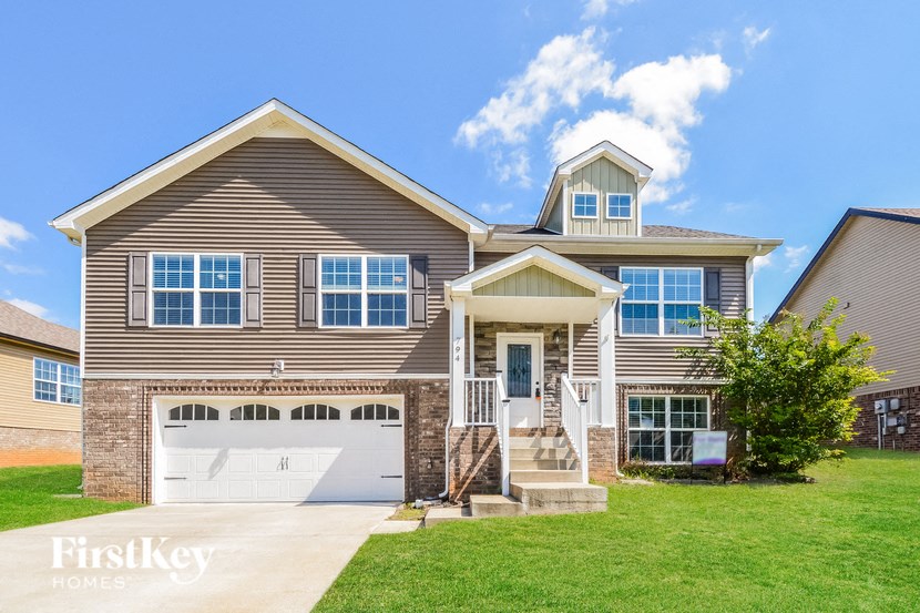 A two-story house with a garage and a front porch.