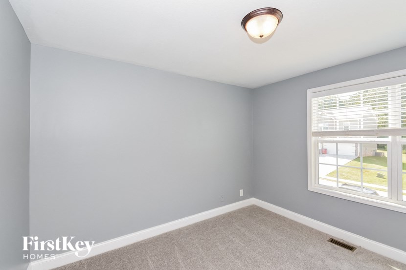 A room with a window and a ceiling light.