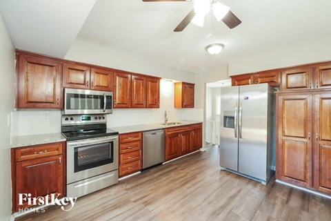 A kitchen with wooden cabinets and stainless steel appliances.