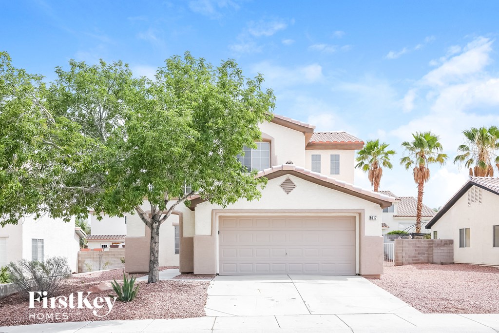 A house with a tree in front of it.